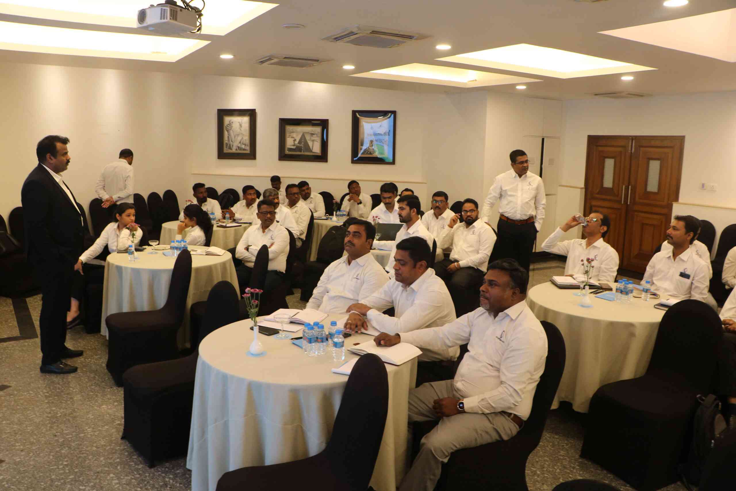 A group of professionals gathered for Optima Life's annual meeting, reflecting collaboration, innovation, and strategic planning for future growth and success.